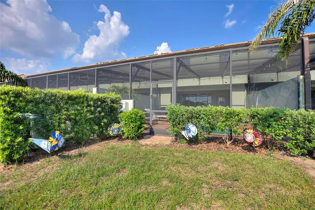 a view of a backyard with plants and a patio