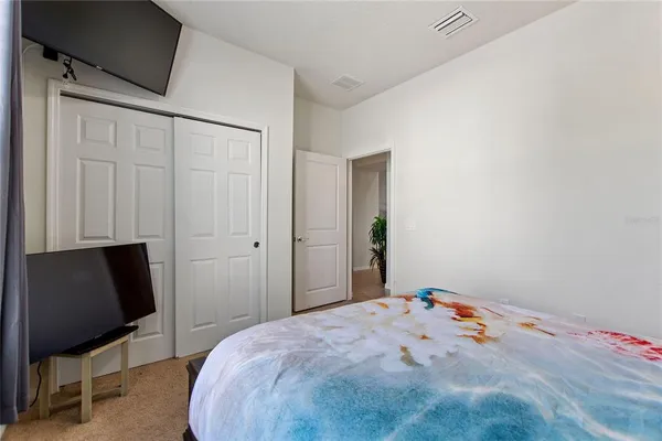 a bedroom with a bed and a chair