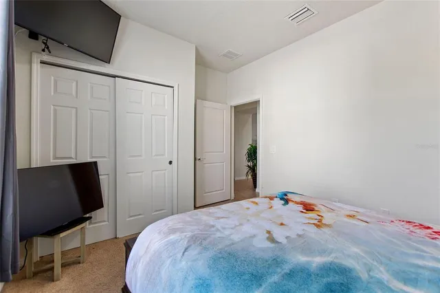 a bedroom with a bed and a chair