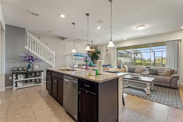 a kitchen with stainless steel appliances granite countertop a sink and cabinets