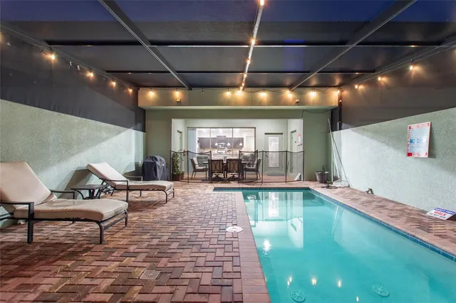 a living room with furniture and a pool table with fireplace