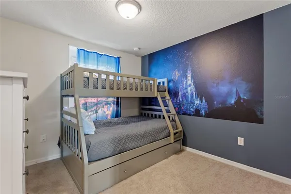 a bedroom with a large bed and a window