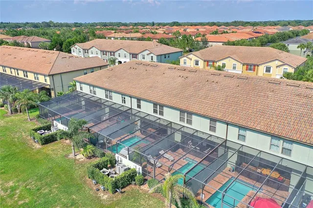 an aerial view of residential houses with outdoor space