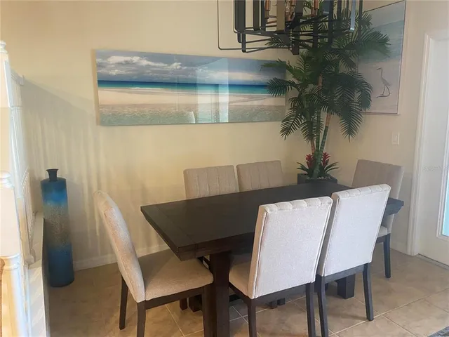 a view of a dining room with furniture and a potted plant