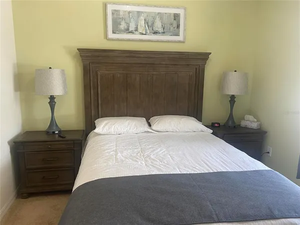 a bedroom with a bed and a dresser