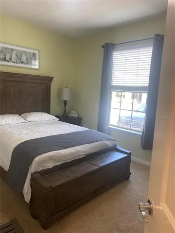 a bedroom with a bed and window