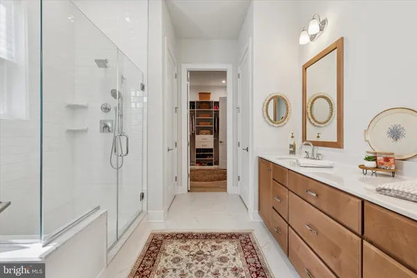 a bathroom with a double vanity sink mirror and shower
