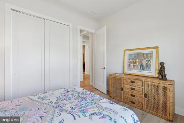a bedroom with a bed and a dresser