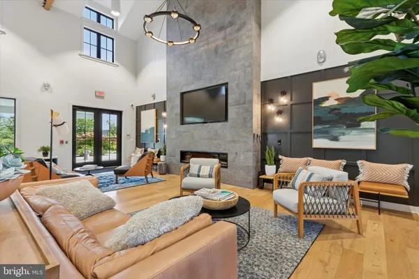 a living room with furniture wooden floor and a flat screen tv