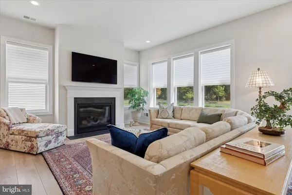 a living room with furniture large window and a fireplace