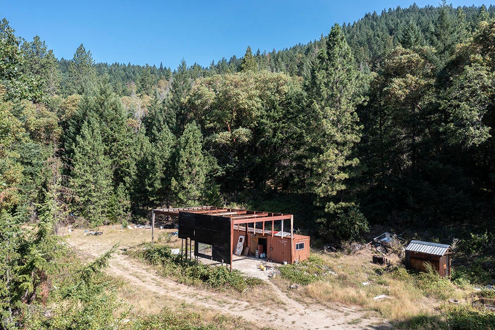 780 Hitching Post Road Grants Pass, OR 97526 - Photo 18 of 21 skeleton of potential shop with slab floor and shed.