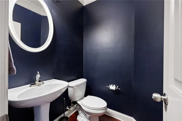 a bathroom with a sink mirror and toilet
