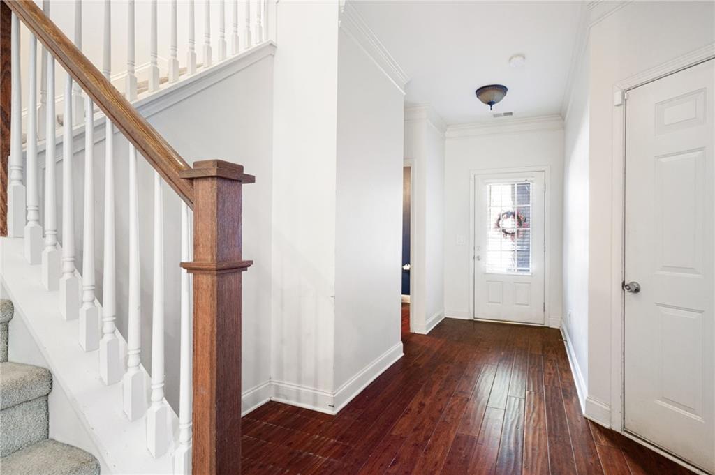 138 Trailside Way Hiram, GA 30141 - Photo 18 of 35 a view of a hallway with wooden floor and staircase