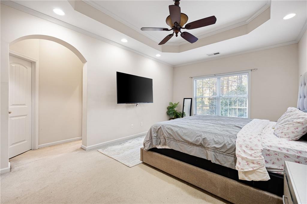 138 Trailside Way Hiram, GA 30141 - Photo 21 of 35 a spacious bedroom with a bed and a flat screen tv