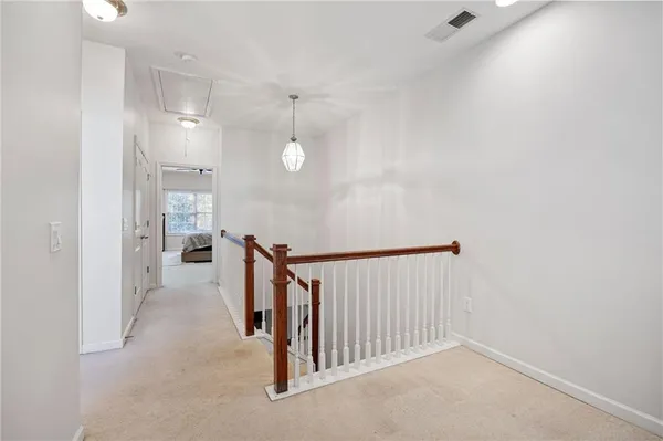a view of a hallway with stairs