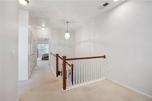 a view of a hallway with stairs