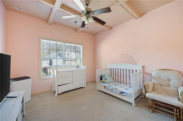 a room with furniture and ceiling fan