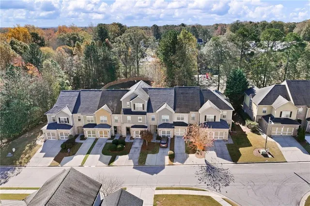 an aerial view of a house with swimming pool and mountain view