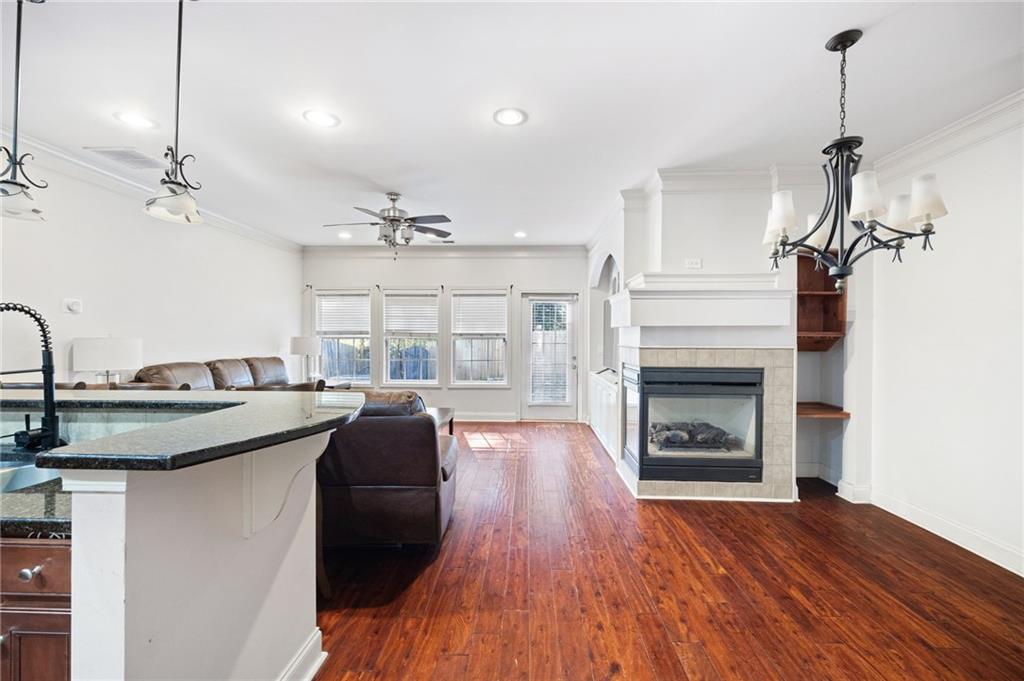 138 Trailside Way Hiram, GA 30141 - Photo 4 of 35 a kitchen with a sink a fireplace and wooden floor