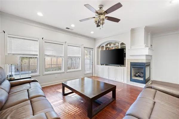 a living room with furniture fireplace and flat screen tv