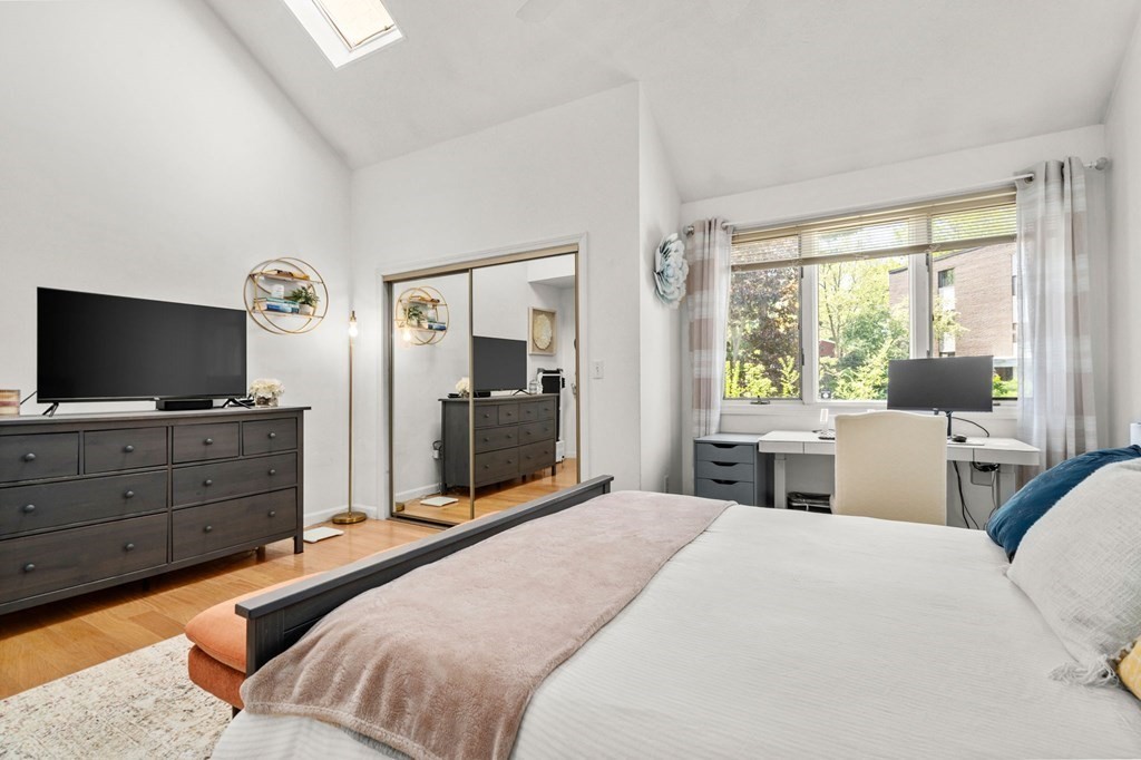 53 South Walnut Street, Unit 2 Quincy, MA 02169 - Photo 11 of 24 a bedroom with a bed and a flat screen tv
