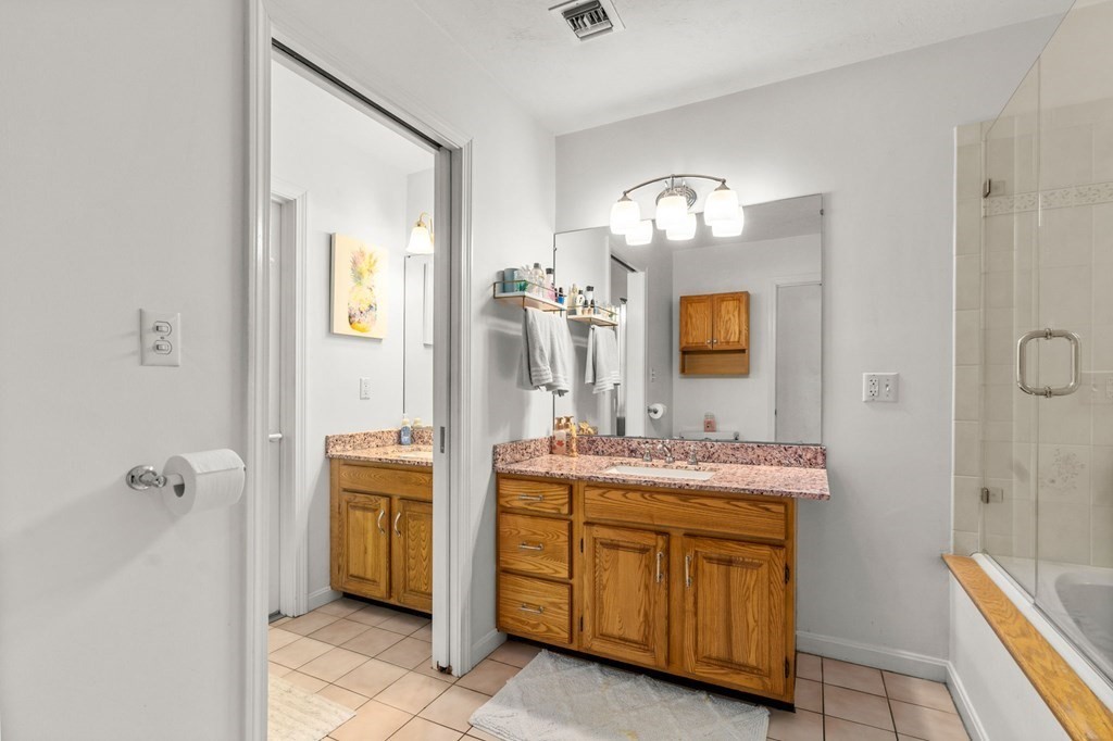 53 South Walnut Street, Unit 2 Quincy, MA 02169 - Photo 14 of 24 a en suite bathroom with a double vanity sink and a mirror