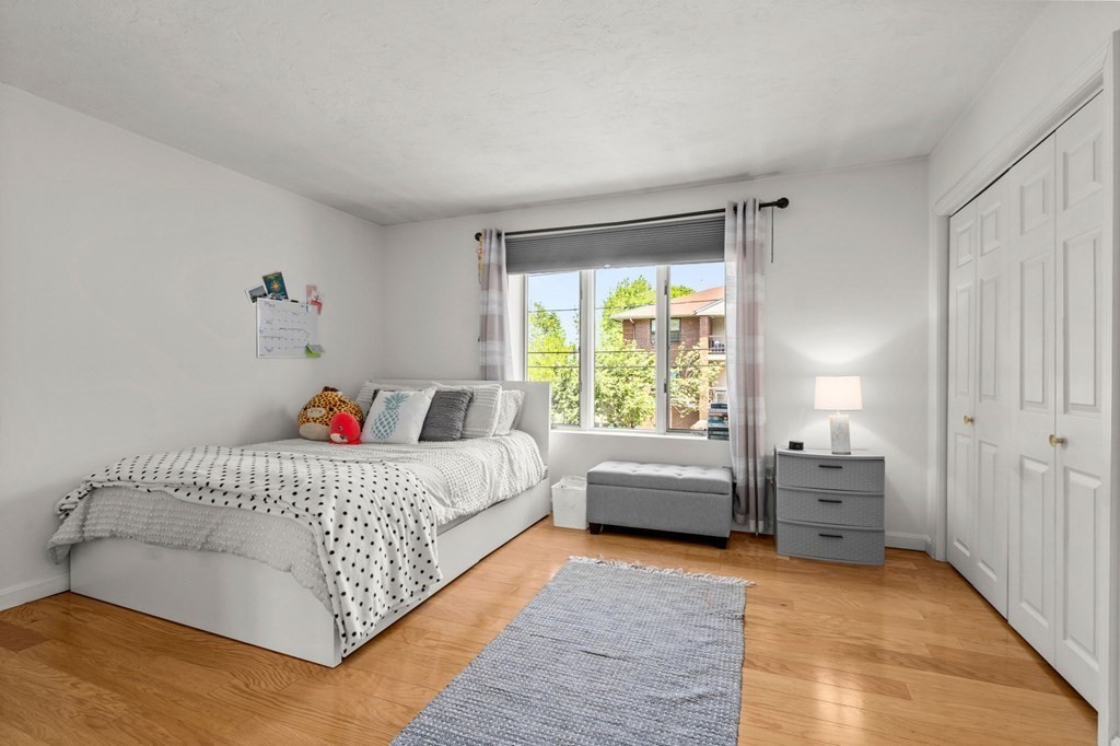 53 South Walnut Street, Unit 2 Quincy, MA 02169 - Photo 17 of 24 a room with a bed and a couch