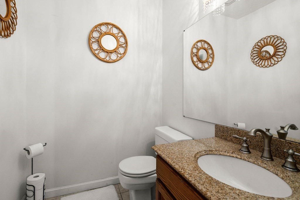 53 South Walnut Street, Unit 2 Quincy, MA 02169 - Photo 21 of 24 a bathroom with a granite countertop sink and a mirror