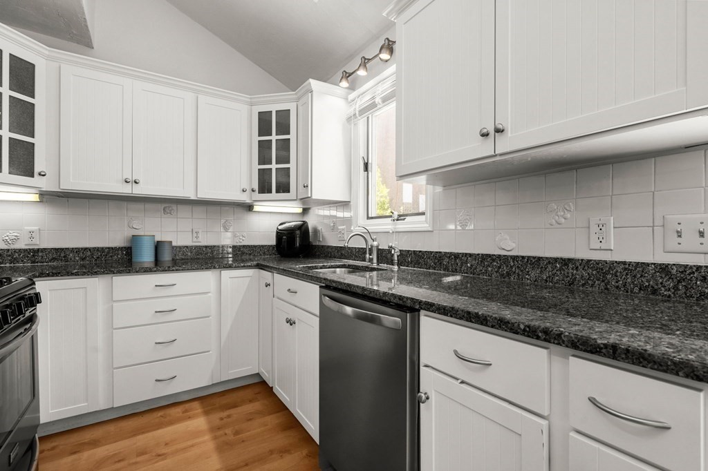 53 South Walnut Street, Unit 2 Quincy, MA 02169 - Photo 4 of 24 a kitchen with granite countertop white cabinets and white appliances