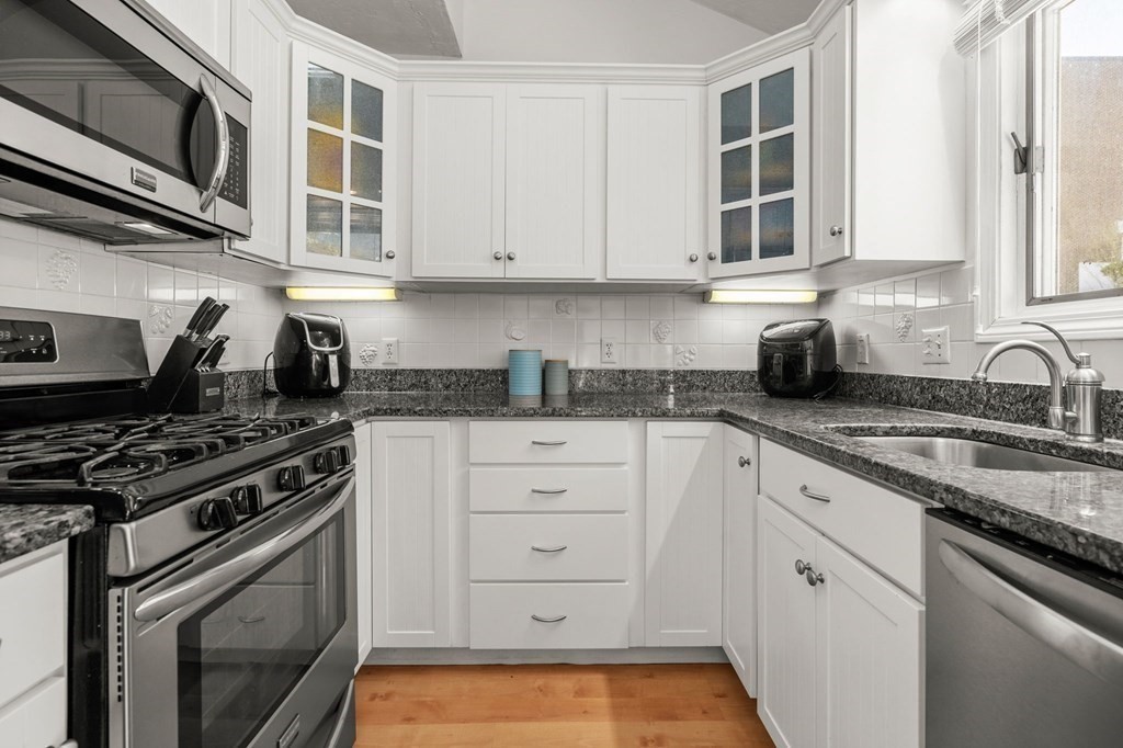 53 South Walnut Street, Unit 2 Quincy, MA 02169 - Photo 5 of 24 a kitchen with stainless steel appliances granite countertop a stove and a sink