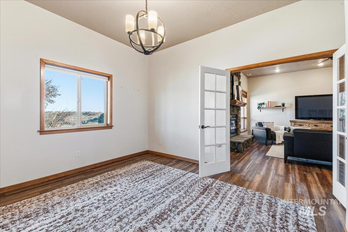 7434 Lanktree Lane Middleton, ID 83644 - Photo 20 of 34 Unfurnished office with french doors, a chandelier, and dark wood finished floors