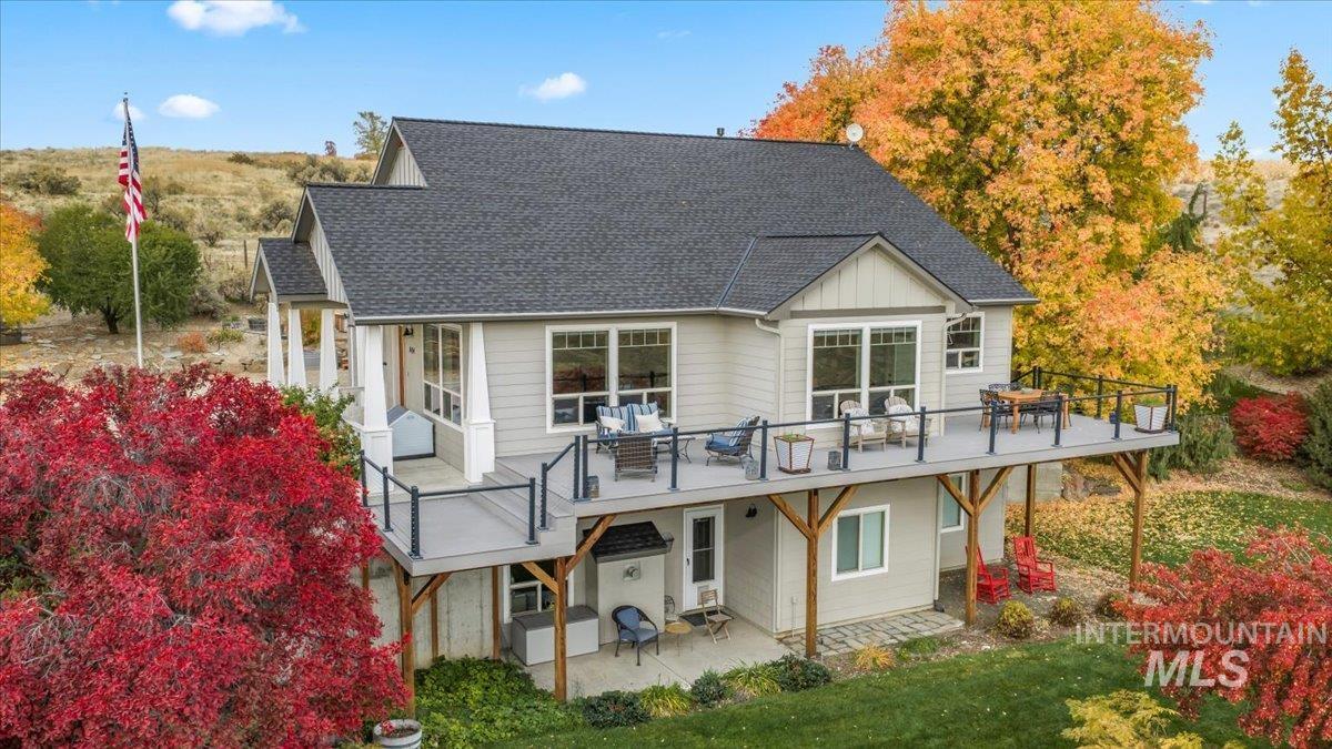 7434 Lanktree Lane Middleton, ID 83644 - Photo 22 of 34 Back of property featuring a shingled roof, board and batten siding, and a patio