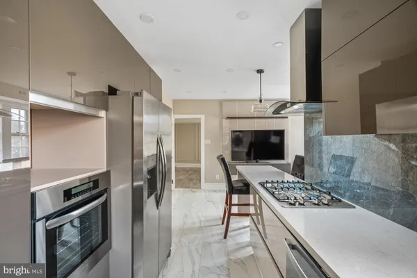 a kitchen with a stove and a refrigerator
