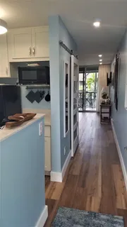 a kitchen with a refrigerator and a stove top oven