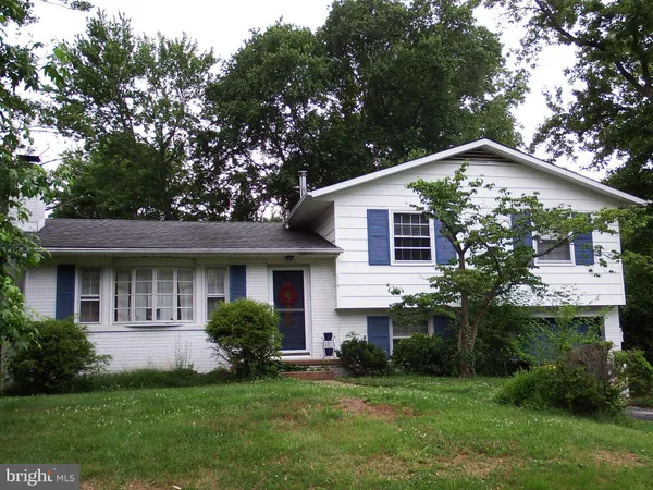 a front view of house with a garden