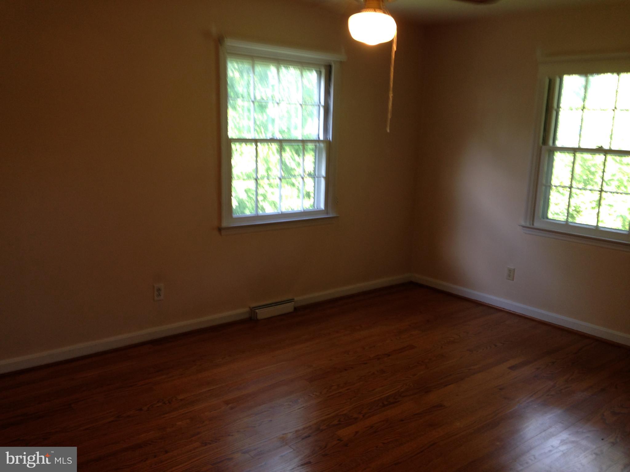 114 Dallas Avenue Newark, DE 19711 - Photo 11 of 18 an empty room with wooden floor and windows