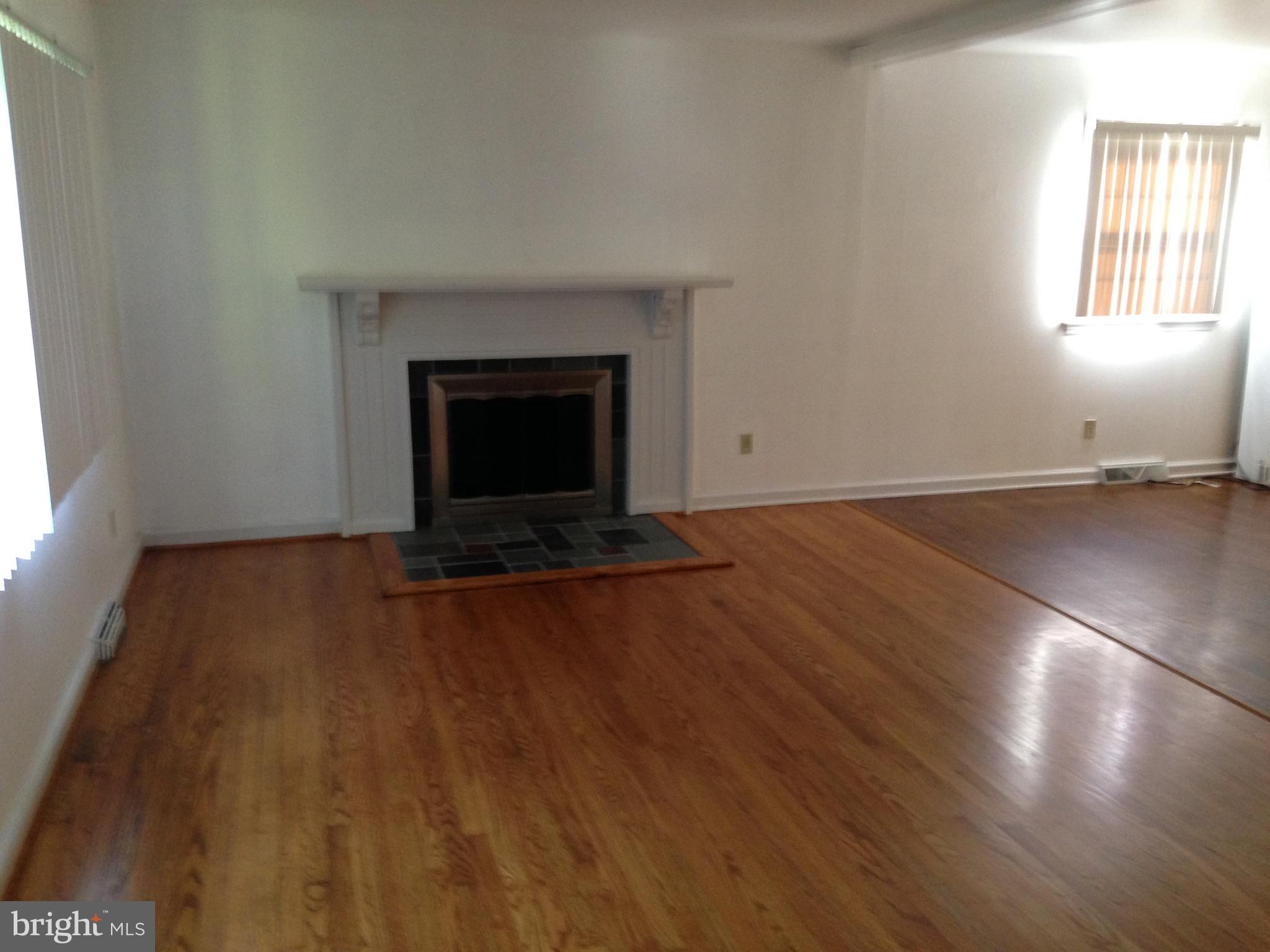 114 Dallas Avenue Newark, DE 19711 - Photo 3 of 18 an empty room with windows and fireplace
