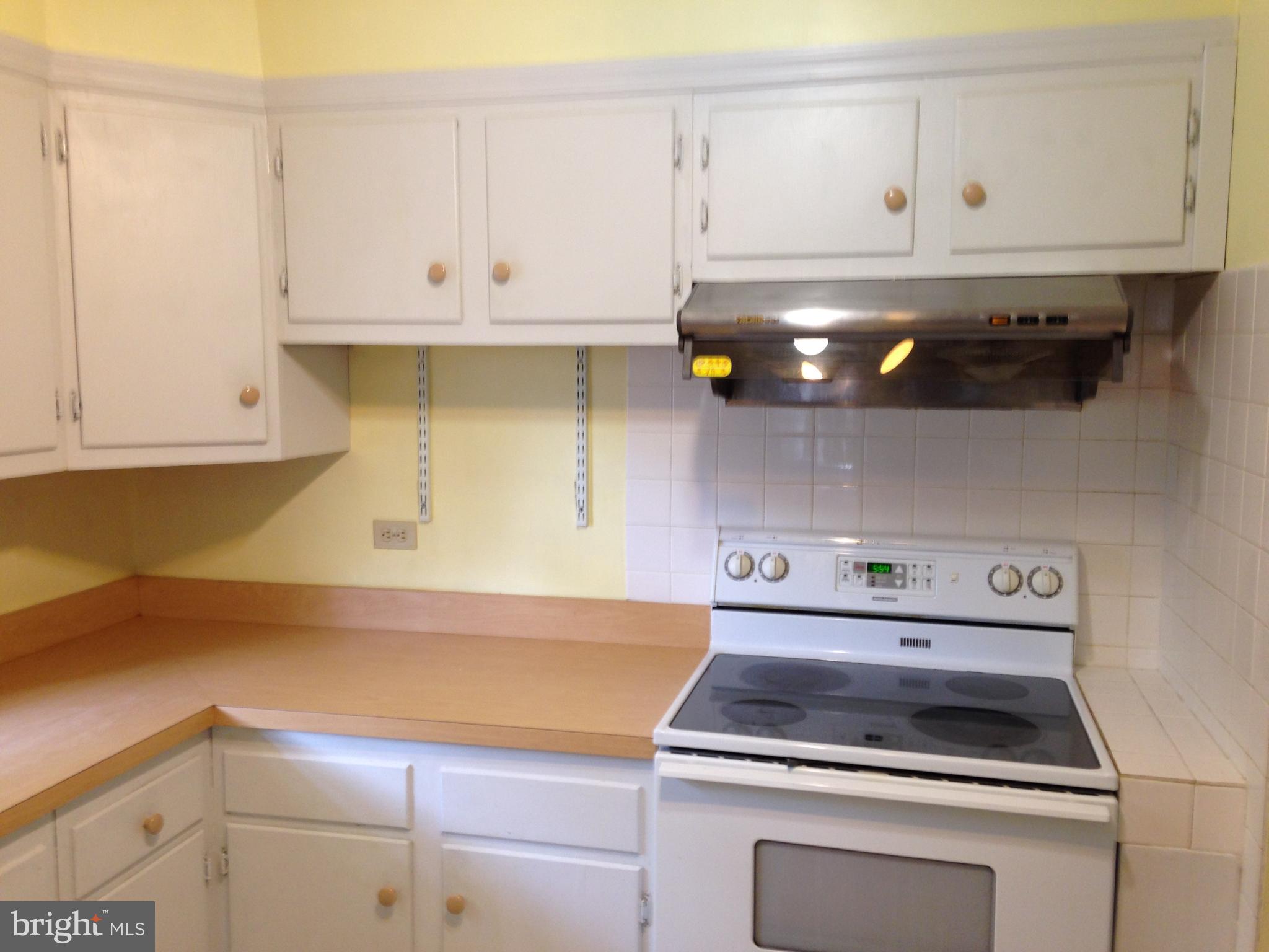 114 Dallas Avenue Newark, DE 19711 - Photo 5 of 18 a kitchen with white cabinets and appliances