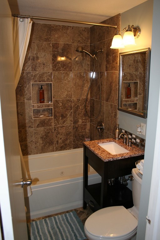 252 Cooper Street Springfield, MA 01108 - Photo 13 of 22 a bathroom with a sink a toilet a mirror and bathtub