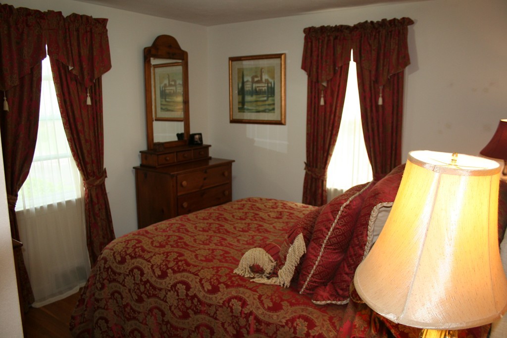 252 Cooper Street Springfield, MA 01108 - Photo 17 of 22 a bedroom with a bed and wooden floor