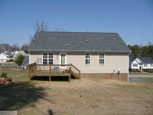 6907 Channel Forest Road Belews Creek, NC 27009 - Photo 12 of 14 Exterior Back. Deck is perfect for entertaining and relaxing