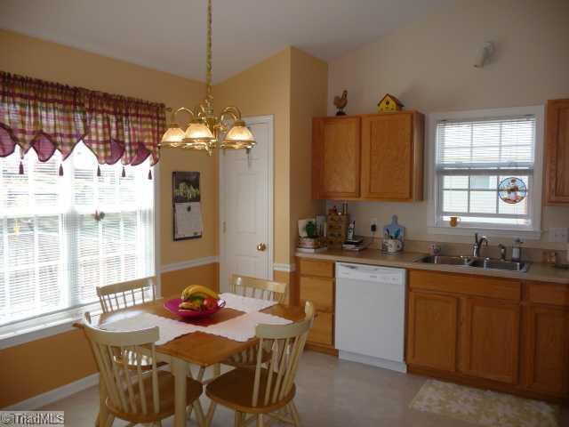 6907 Channel Forest Road Belews Creek, NC 27009 - Photo 3 of 14 Kitchen. Large eat-in kitchen with chair rail, vaulted ceiling, and French door leading to deck!