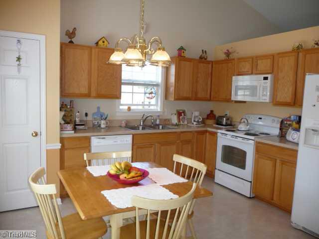 6907 Channel Forest Road Belews Creek, NC 27009 - Photo 4 of 14 Kitchen. Plenty of cabinets, pantry, new dishwasher & stove, and built-in microwave. Also the side by side refrigerator, washer & dryer all stay!!