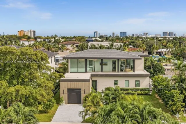 a view of a city that has a lot of plants and palm trees