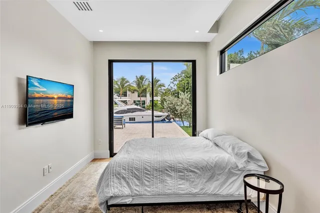 a bedroom with a bed and a flat screen tv