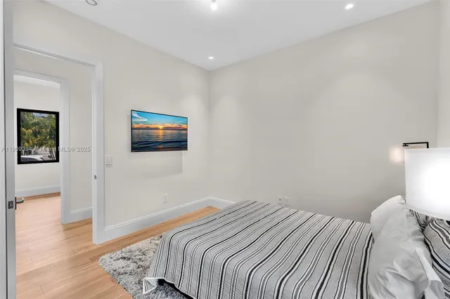 a bedroom with a bed and painting on the wall