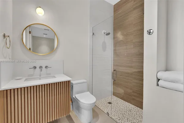 a bathroom with a toilet a sink and a mirror