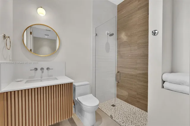 a bathroom with a toilet a sink and a mirror