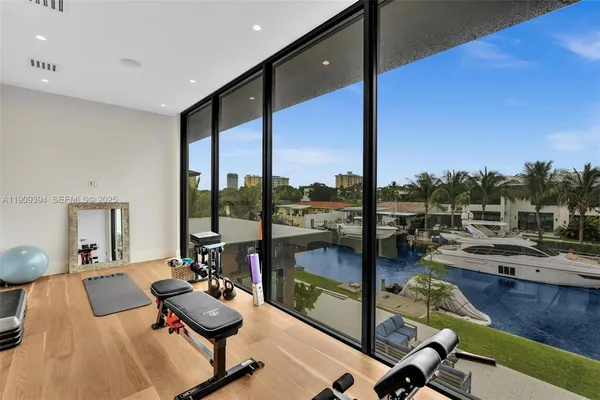 a large bedroom with a large bed and a large window with outer view