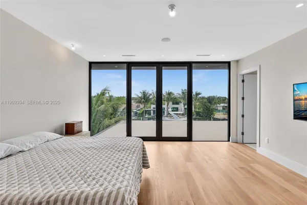a large bedroom with a large bed and a large window